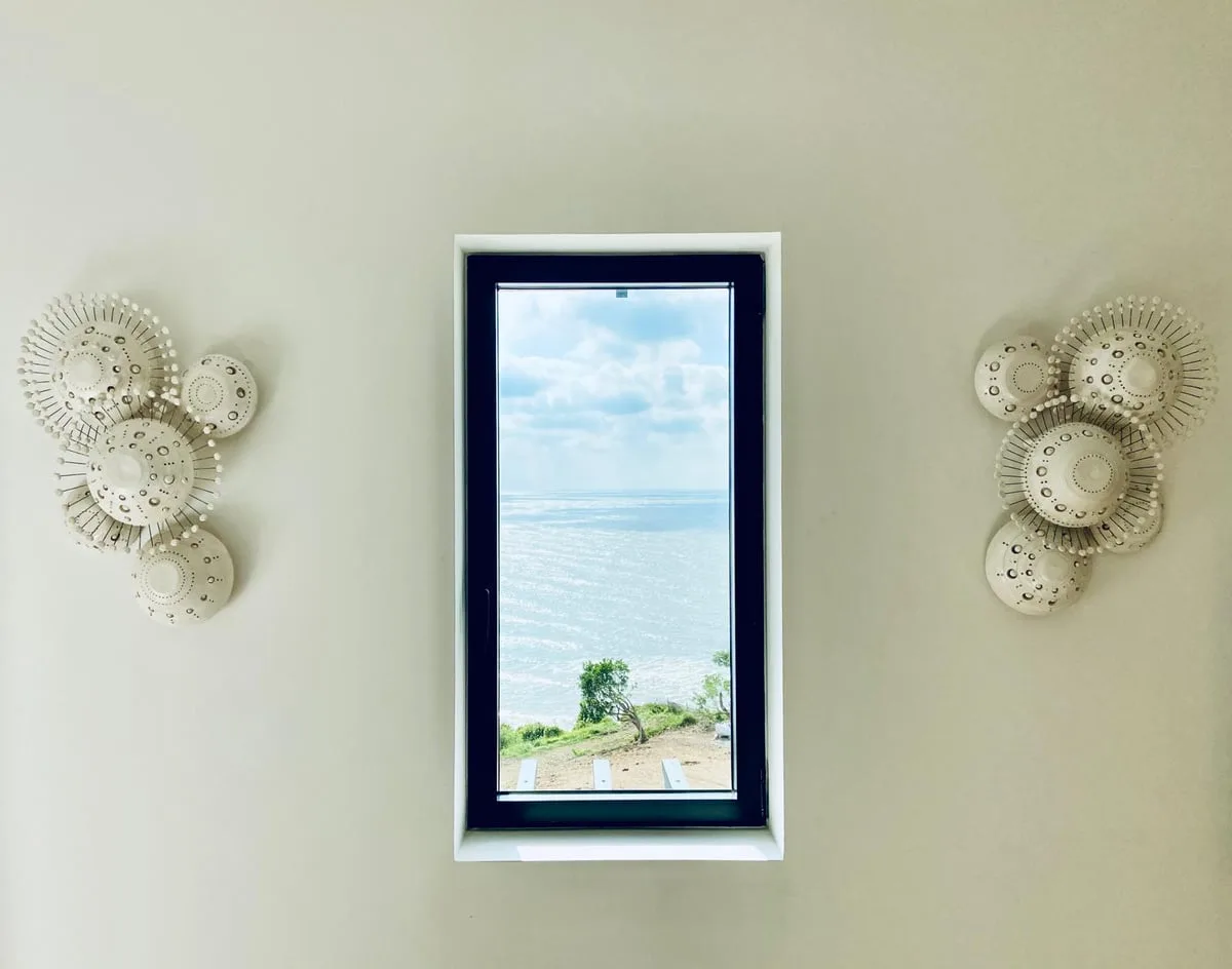 Sunshine wall sconces in glazed white ceramic by Georges Pelletier